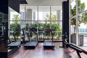 a gym with a bunch of treadmills in a building at Veone Hotel Kuala Lumpur in Kuala Lumpur