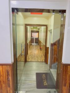 a hallway in a building with a glass wall at Hotel Mirana Pvt Ltd in Kathmandu