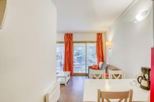 a living room with a table and a couch at Flat With Swimming Pool Near The Beach in Sanary-sur-Mer