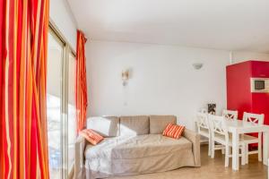 a living room with a couch and a table at Flat With Swimming Pool Near The Beach in Sanary-sur-Mer