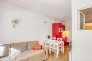 a living room with a couch and a table at Flat With Swimming Pool Near The Beach in Sanary-sur-Mer