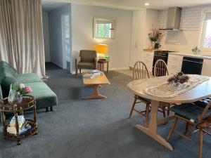a living room with a green couch and a table at Bruny Sunset Beach in Alonnah