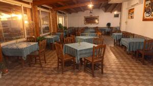 a dining room with tables and chairs with blue tables at Locanda Adele in Parghelia