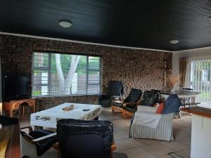 a living room with a table and chairs at Dollery House in Port Alfred