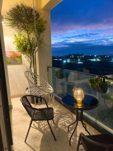 a balcony with a hammock and a table and chairs at SeaBreeze Resort Baku Apartment Studio in Baku