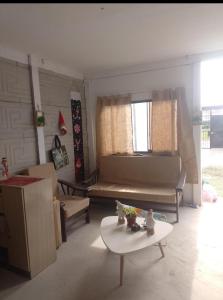 a living room with a couch and a table at Tampu Machi Eco Camping in Chancayllo +1 photo