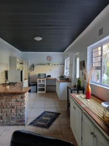 a large kitchen with a counter top in a room at Dollery House in Port Alfred