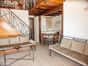 a living room with a couch and a table at Iron House in Agios Georgios +41 photos