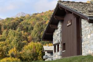 a stone building with a mountain in the background at Le Shantoné in Saint-Michel-de-Maurienne +70 photos