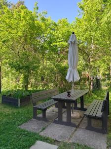 a picnic table with an umbrella next to a picnic table at Peaceful studio in Vantaa in Vantaa