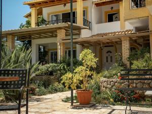 a house with a garden in front of it at Iron House in Agios Georgios