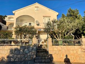 a man standing in front of a house at Apartman Grospic in Cesarica