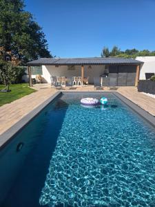 a swimming pool with a pool noodle in the water at Vendée Z'Îles in La Garnache