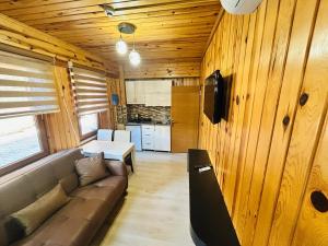 a living room with a couch and a table at TRIA APART OTEL in Uzungöl