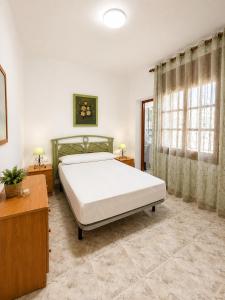 a bedroom with a large bed and two windows at AmetllaDeMar in Les tres Cales +32 photos