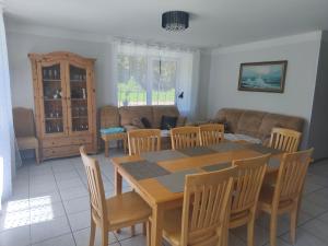 a living room with a table and chairs and a couch at Vormsi Ohvitseride Maja korter nr 3 in Hullo