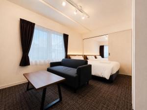 a hotel room with a bed and a couch at Hotel ONE'S RESIDENCE in Sapporo +34 photos