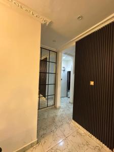 an empty room with a hallway with a glass door at Cozy 2 Bedroom Apartment - Lugbe in Rubuchi