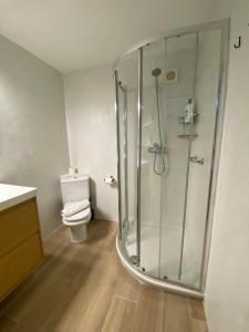 a bathroom with a shower and a toilet at Saona Coast - Apartamento reformado en playa Arenal, Jávea in Jávea +38 photos