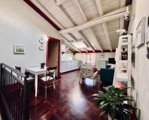 a living room with a staircase and a table and chairs at BoscoLago apartment Lake Iseo & Franciacorta in Iseo