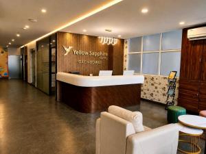 a lobby with a waiting area with a reception desk at Yellow Sapphire Hotel Gachibowli in Hyderabad