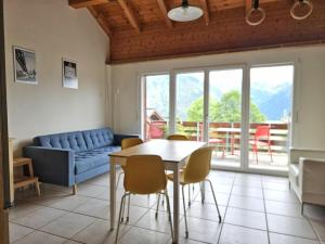 a living room with a table and chairs and a couch at Revier Silberwiidä-Galerie in Braunwald +5 photos