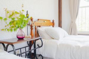 a bedroom with two beds and a table with a plant at REIBA STYLE Hotel in Nagasawa +6 photos