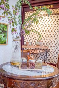a table with jars and a vase with flowers on it at REIBA STYLE Hotel in Nagasawa