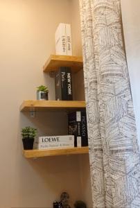 a shelf in a room with books at Dephil stays in Jinja