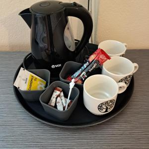 a tray with a tea kettle and cups on a table at Villa Rimari in Ohrid