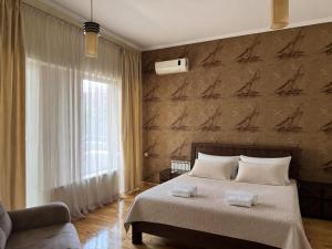 a bedroom with a bed with two towels on it at Villa Kobuleti in Kobuleti