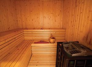 a sauna with a bucket in a wooden room at The Heritage Courtyard in Siem Reap