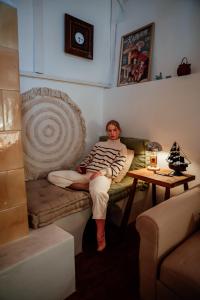 a man laying on a couch in a living room at Baglyashegy Vendégház in Sümeg +35 photos