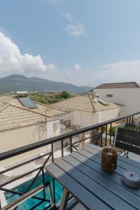 a balcony with a bench and a view of some buildings at Diamanti Villa, Pool & Barbecue in Skala Potamias +22 photos