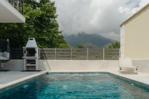 a swimming pool with a view of a mountain at Diamanti Villa, Pool & Barbecue in Skala Potamias