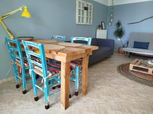 a wooden table and chairs in a living room at B&B Hestia's Hideaway in Kalívia Thorikoú
