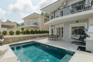 a villa with a swimming pool and a house at Diamanti Villa, Pool & Barbecue in Skala Potamias