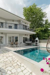 a villa with a swimming pool and a house at Diamanti Villa, Pool & Barbecue in Skala Potamias