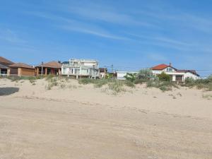 an empty road in front of houses on a beach at Отель Семейный in Zatoka