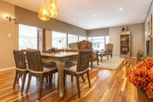 a dining room with a table and chairs at Arbour1 Guesthouse in George