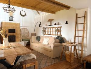 a living room with a couch and a table at Baglyashegy Vendégház in Sümeg