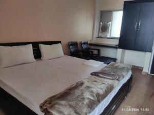 a bedroom with a large bed in a room at Adharshila hotel & Dormitory in Shahdol