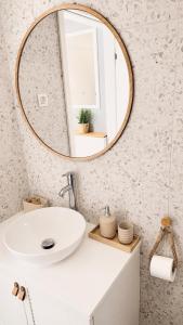 a bathroom with a white sink and a mirror at SEAESTA Cosy Sea Apartment in Koper +19 photos