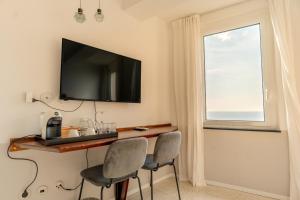 a room with a table and two chairs and a window at Agave Room Rental in Riomaggiore