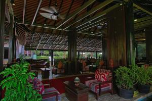 a lobby of a resort with chairs and plants at The Heritage Courtyard in Siem Reap