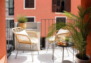 a patio with chairs and a table with a candle at SEAESTA Cosy Sea Apartment in Koper