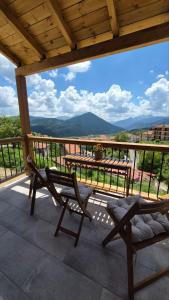a patio with a table and chairs on a balcony at Stone Loft Suite in Karpenisi