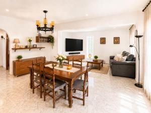 a living room with a table and a couch at AmetllaDeMar in Les tres Cales