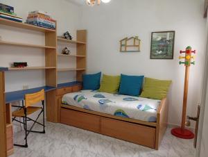 a bedroom with a bed and a desk and shelves at Vistas Al Mar E Isla De La Toja in O Grove