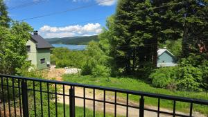 a balcony with a view of a house and a lake at Pine Apartments Mavrovo in Mavrovo